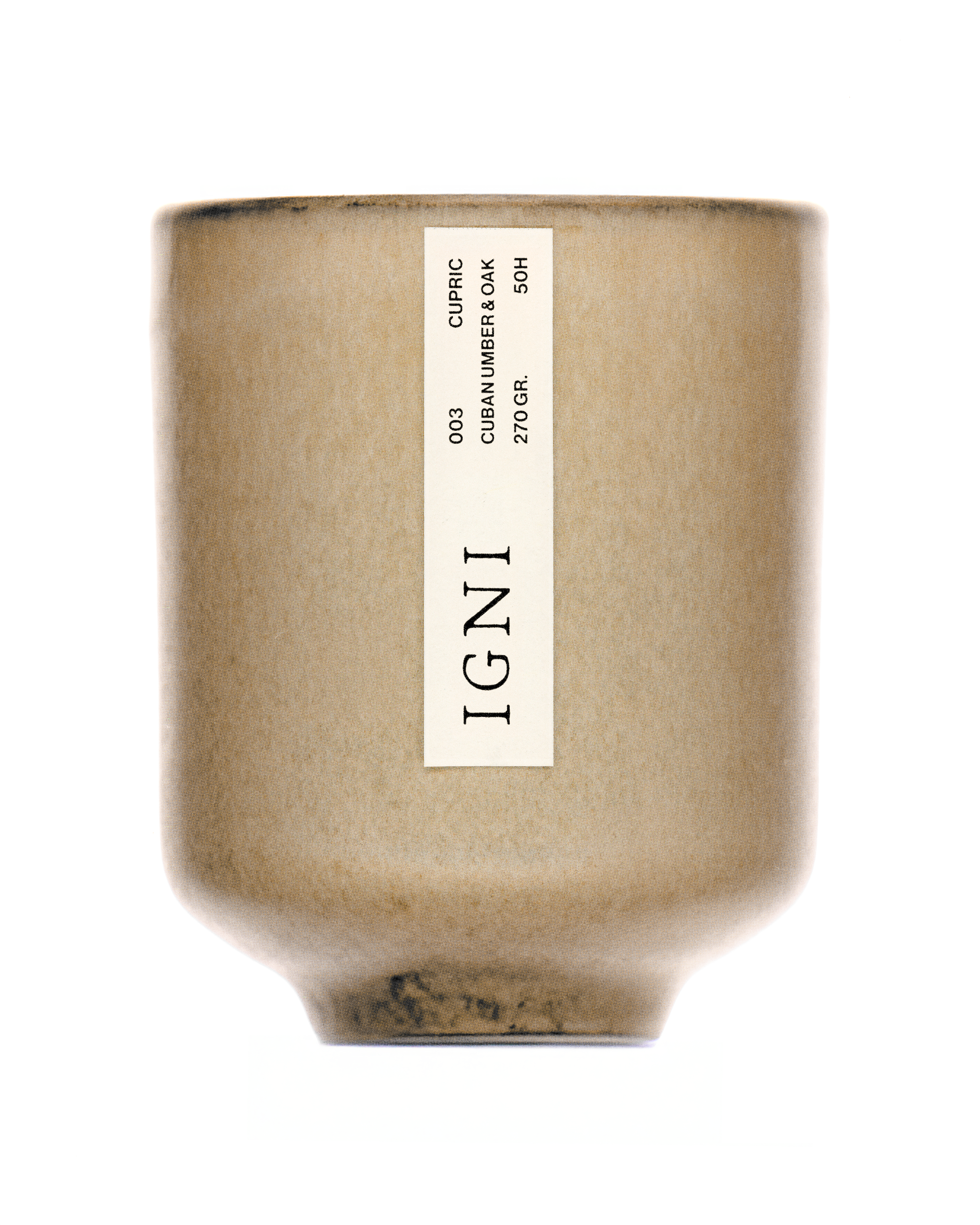 Product image of the IGNI Cupric Cuban Umber & Oak luxury scented candle in a beige ceramic vessel, featuring a minimalist vertical label on a clean white background.